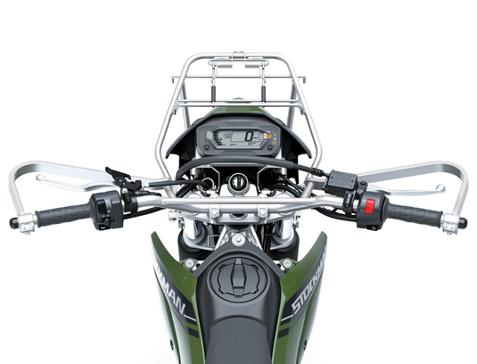 A close-up top-down view of a motorcycle's handlebars, digital dashboard, and front luggage rack, mounted on a green and black bike.